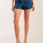 Flying Tomato denim shorts with a drive-in movie print, featuring a stylish indigo denim design and casual fit.