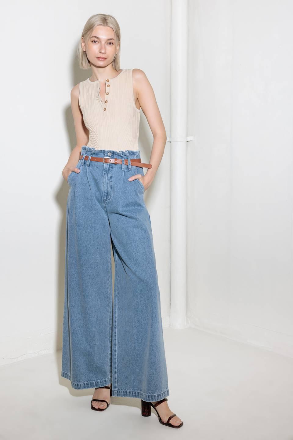 Light denim Flying Tomato Kissed by Sunlight denim pants shown on a hanger with a close-up of fabric texture.