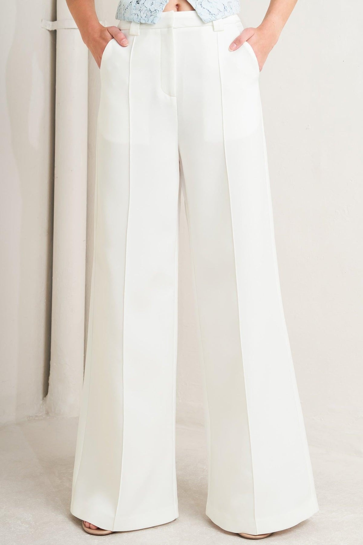 White woven pants from Bright Moments by Flying Tomato, featuring a relaxed fit and textured fabric.