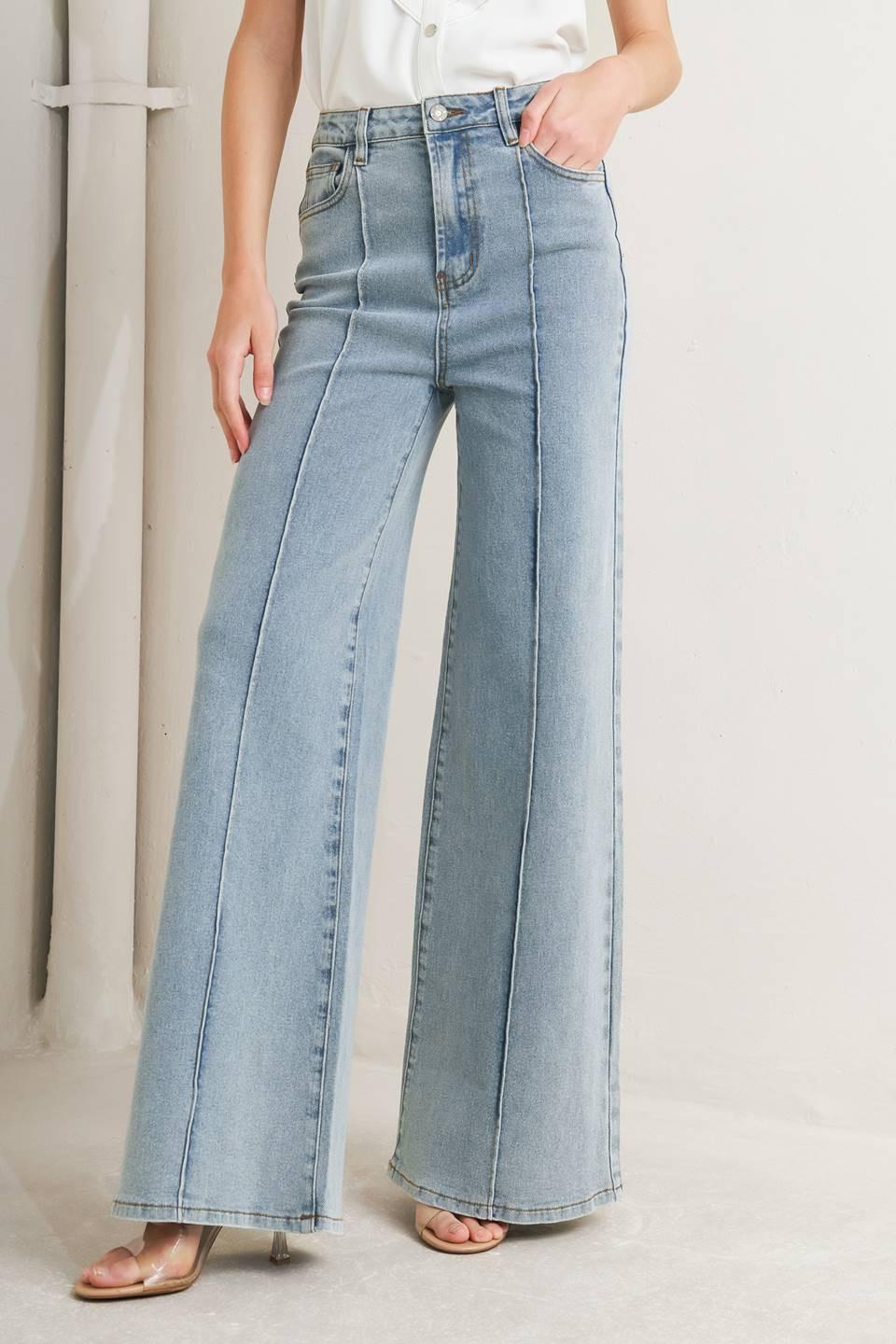 Light wash modern neutral denim pants by Flying Tomato, showcasing a relaxed fit with classic denim details.