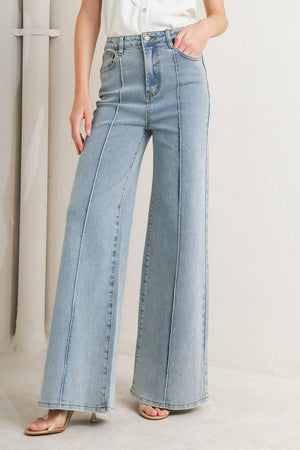 Light wash modern neutral denim pants by Flying Tomato, showcasing a relaxed fit with classic denim details.