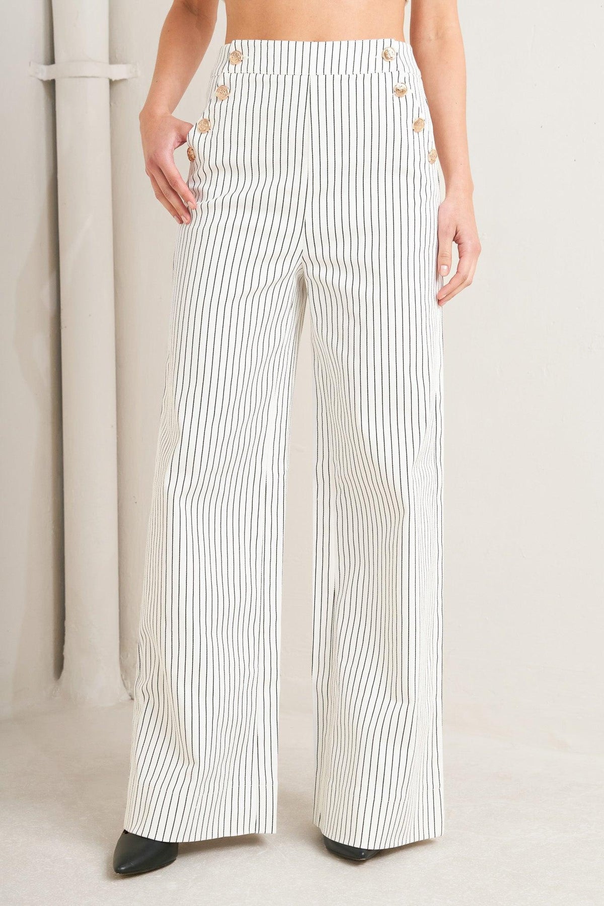 Flying Tomato Effortless Form Stripe Woven Pants in white with vertical stripes, showcasing a relaxed fit and woven fabric detail.