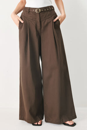 Brown Sugar woven pants by Flying Tomato featuring a stylish, textured woven fabric and a relaxed fit in a warm brown color.