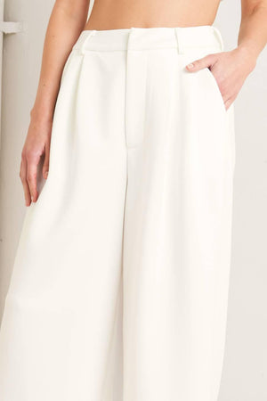 White woven pants from Flying Tomato's Pure Elegance collection, featuring a stylish and comfortable design.