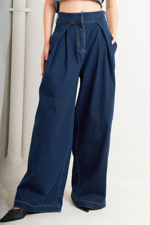 Flying Tomato Quiet Luxe denim pants, slim fit with classic five-pocket design and light blue wash, shown on a model.