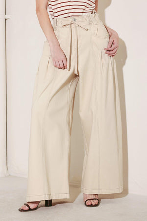 Light beige Flying Tomato Daylight Groove woven pants with a relaxed fit, featuring a textured woven fabric and casual waistband.