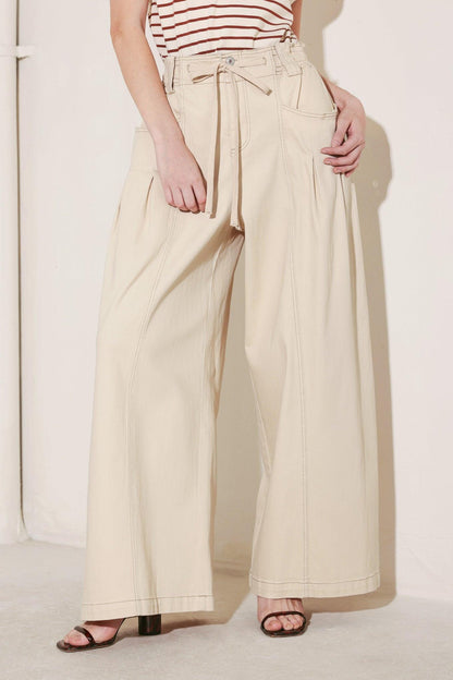Light beige Flying Tomato Daylight Groove woven pants with a relaxed fit, featuring a textured woven fabric and casual waistband.