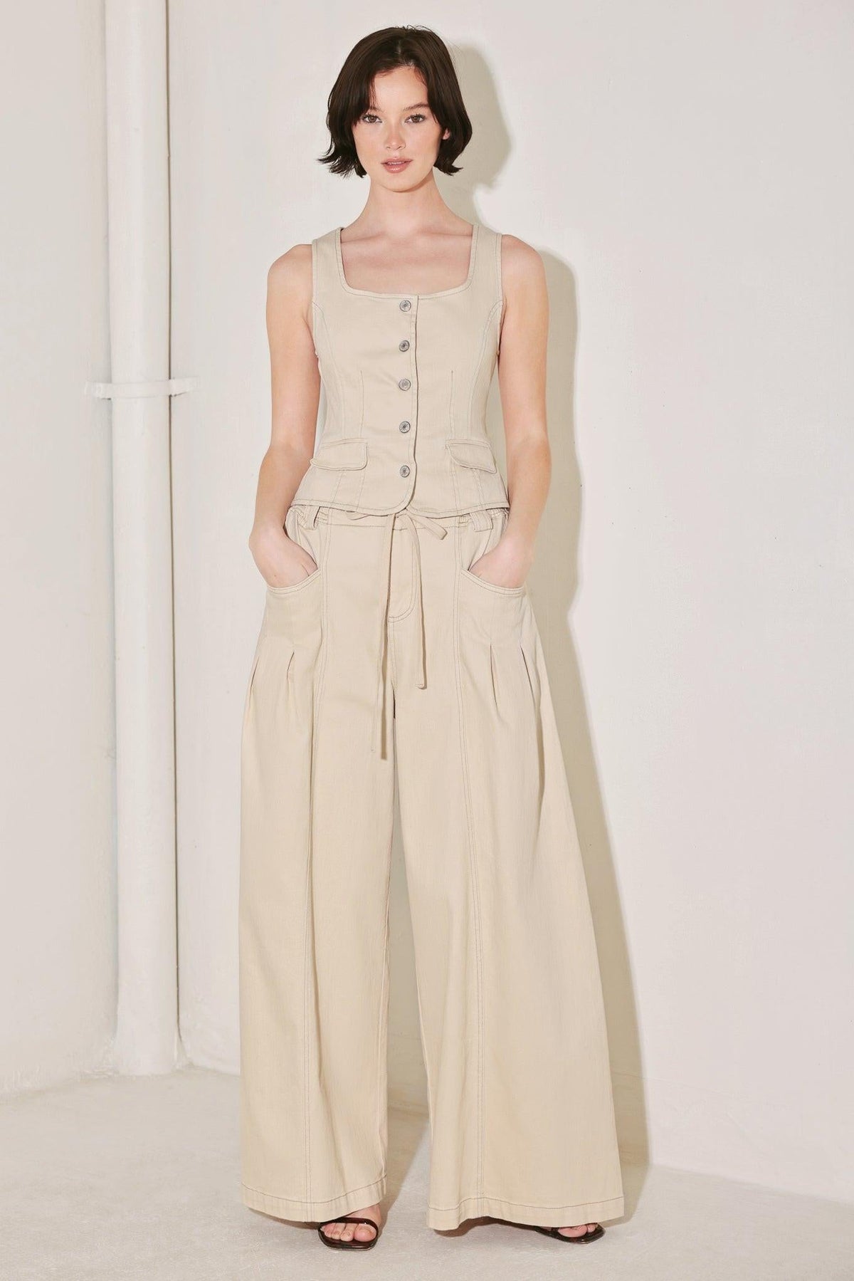 Light beige Flying Tomato Daylight Groove woven pants with a relaxed fit and textured fabric, shown on a model.
