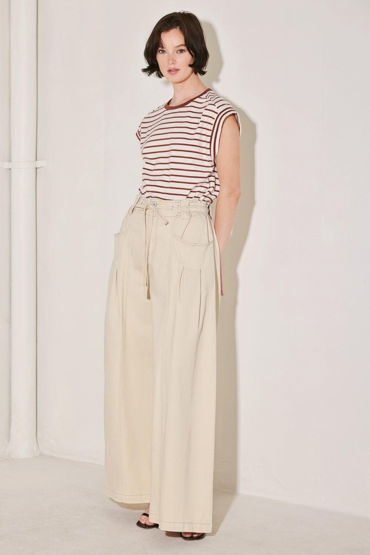 Light beige Flying Tomato Daylight Groove woven pants with a relaxed fit and woven texture, displayed on a neutral background.
