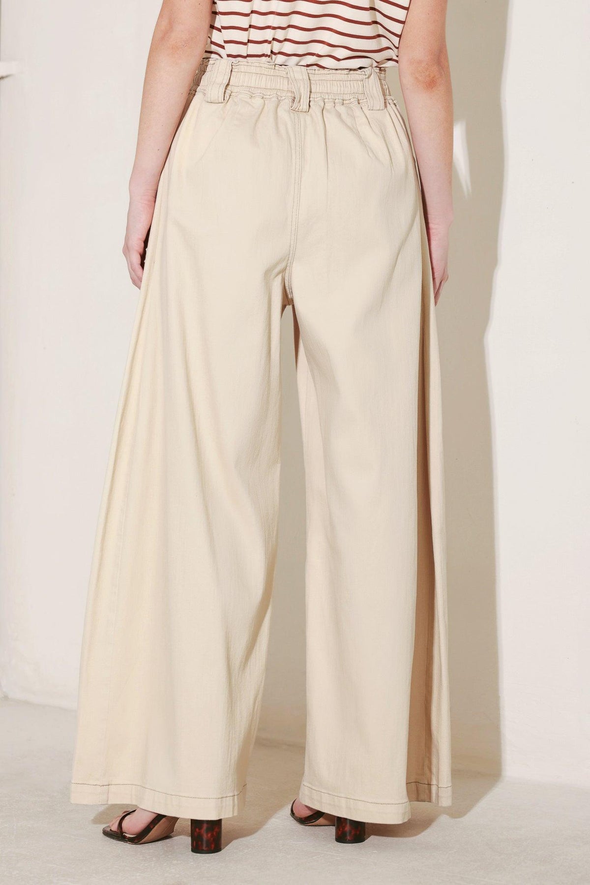 Light beige Flying Tomato Daylight Groove woven pants with a relaxed fit, featuring a textured fabric and stylish design.