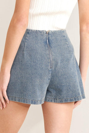 Light indigo Flying Tomato Santa Monica denim skort with front pockets and subtle stitching, styled with casual summer wear.