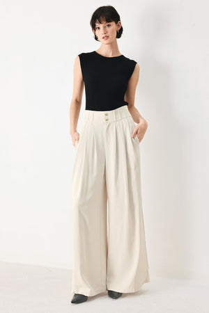 Flying Tomato modern minimal woven pants in neutral color, featuring a sleek fit and woven fabric, displayed on a plain background.
