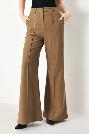 Flying Tomato Rich Silhouette woven pants in brown, featuring a relaxed fit and detailed woven fabric design.