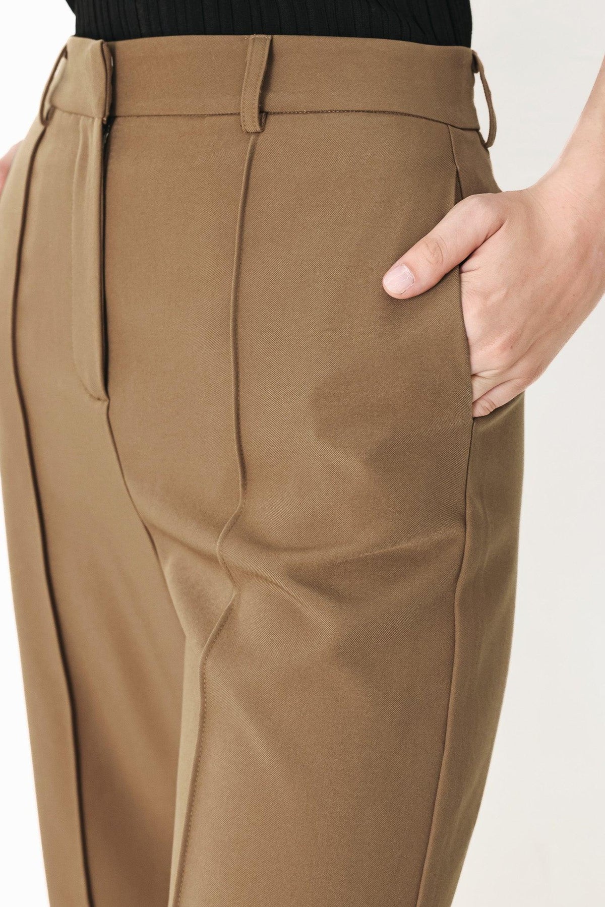 Flying Tomato Rich Silhouette woven pants in brown, showing the relaxed fit and textured fabric with detailed stitching.