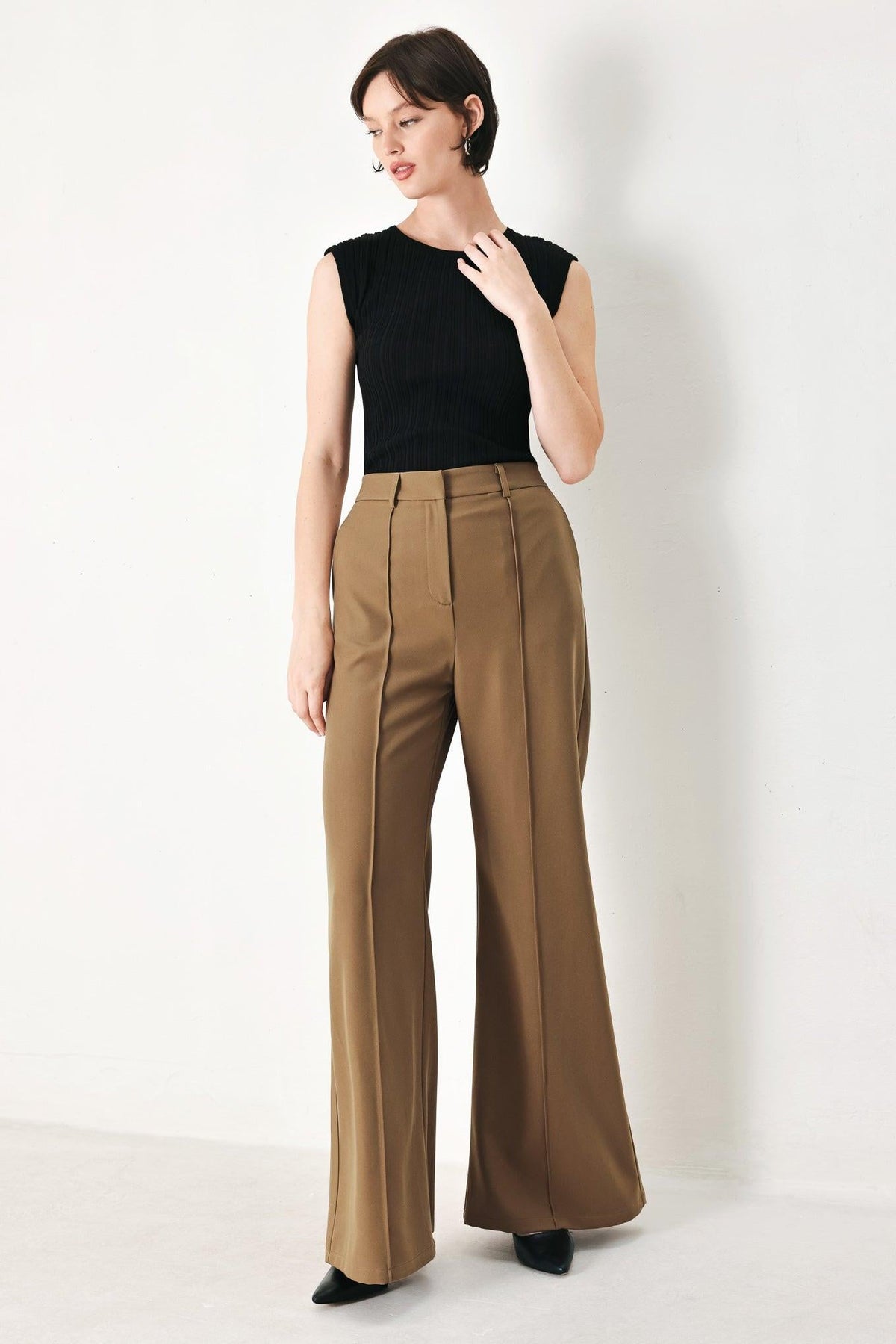 Flying Tomato Rich Silhouette woven pants in brown, showing the relaxed fit and textured fabric with detailed waistband.