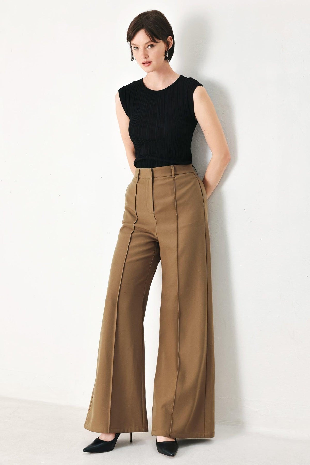 Brown Flying Tomato woven pants with a relaxed fit, featuring a textured silhouette and casual style.