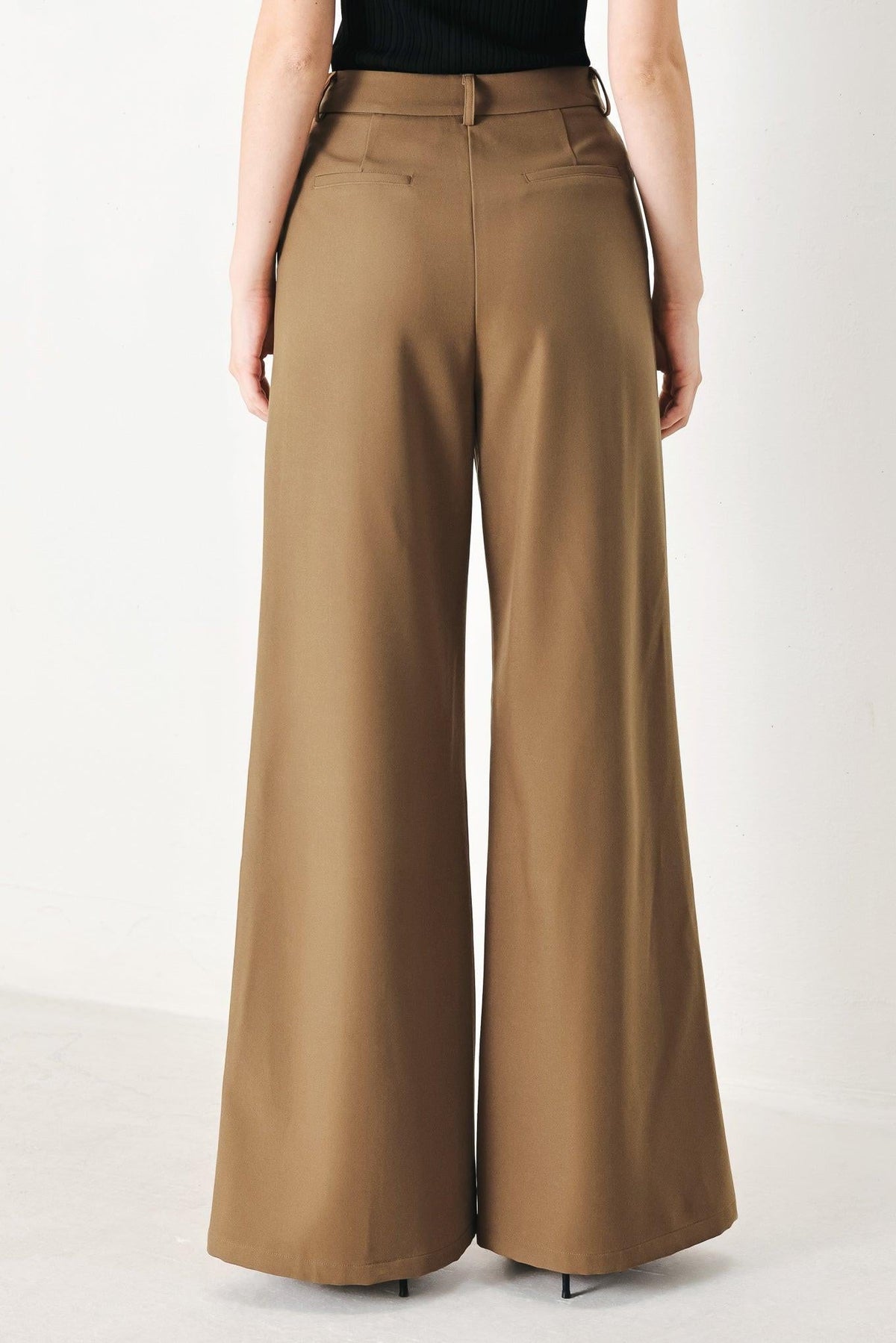 Brown Flying Tomato woven pants with a rich silhouette, featuring a relaxed fit and textured fabric detail.