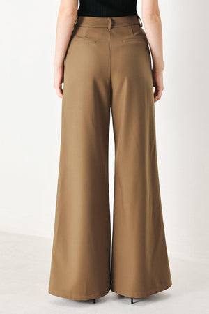 Brown Flying Tomato woven pants with a rich silhouette, featuring a relaxed fit and textured fabric detail.