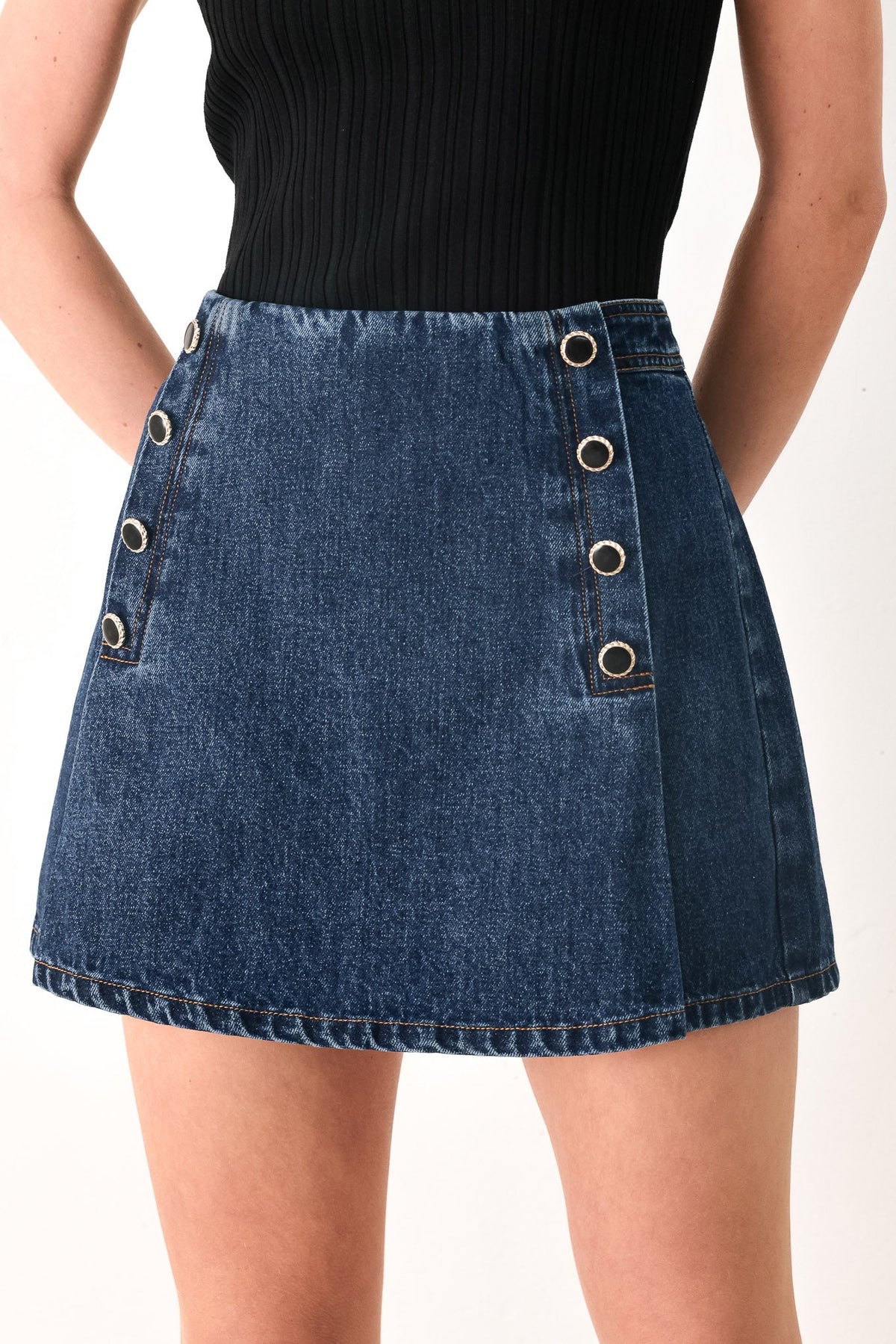 Flying Tomato Run The City denim skort in indigo, showcasing a stylish casual skirt with front pockets and a button closure.