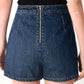 Flying Tomato Run the City denim skort in indigo, featuring a stylish front and back view with pockets and a button closure.