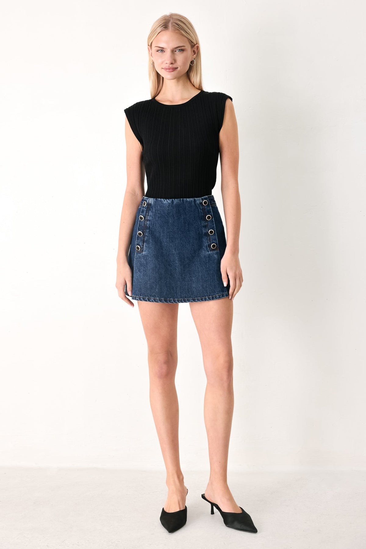 Flying Tomato Run the City denim skort in indigo, showcasing the front view with a button closure and stylish design.