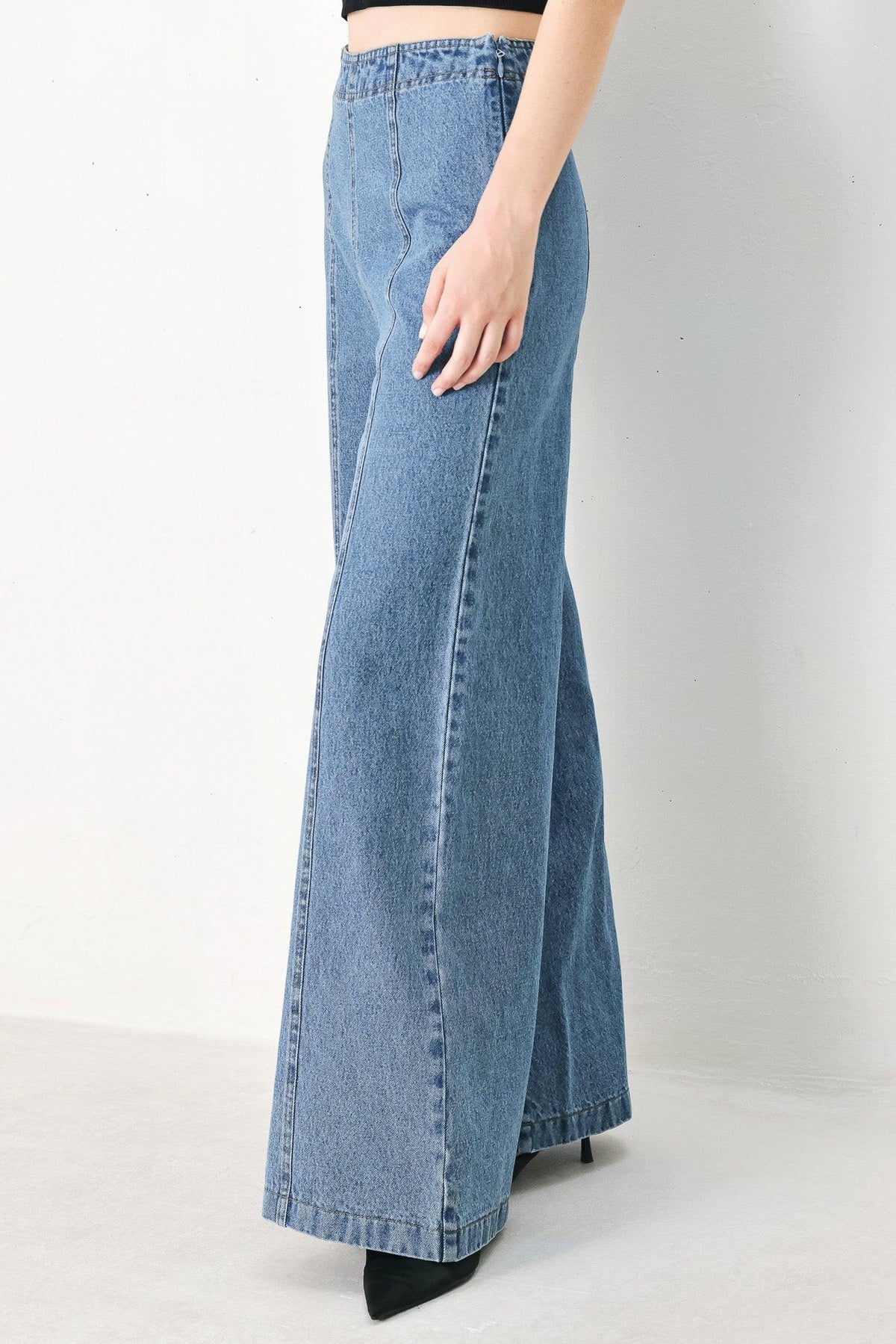 Flying Tomato City Armor denim pants in indigo, slim fit with five-pocket design and belt loops, displayed on a hanger.