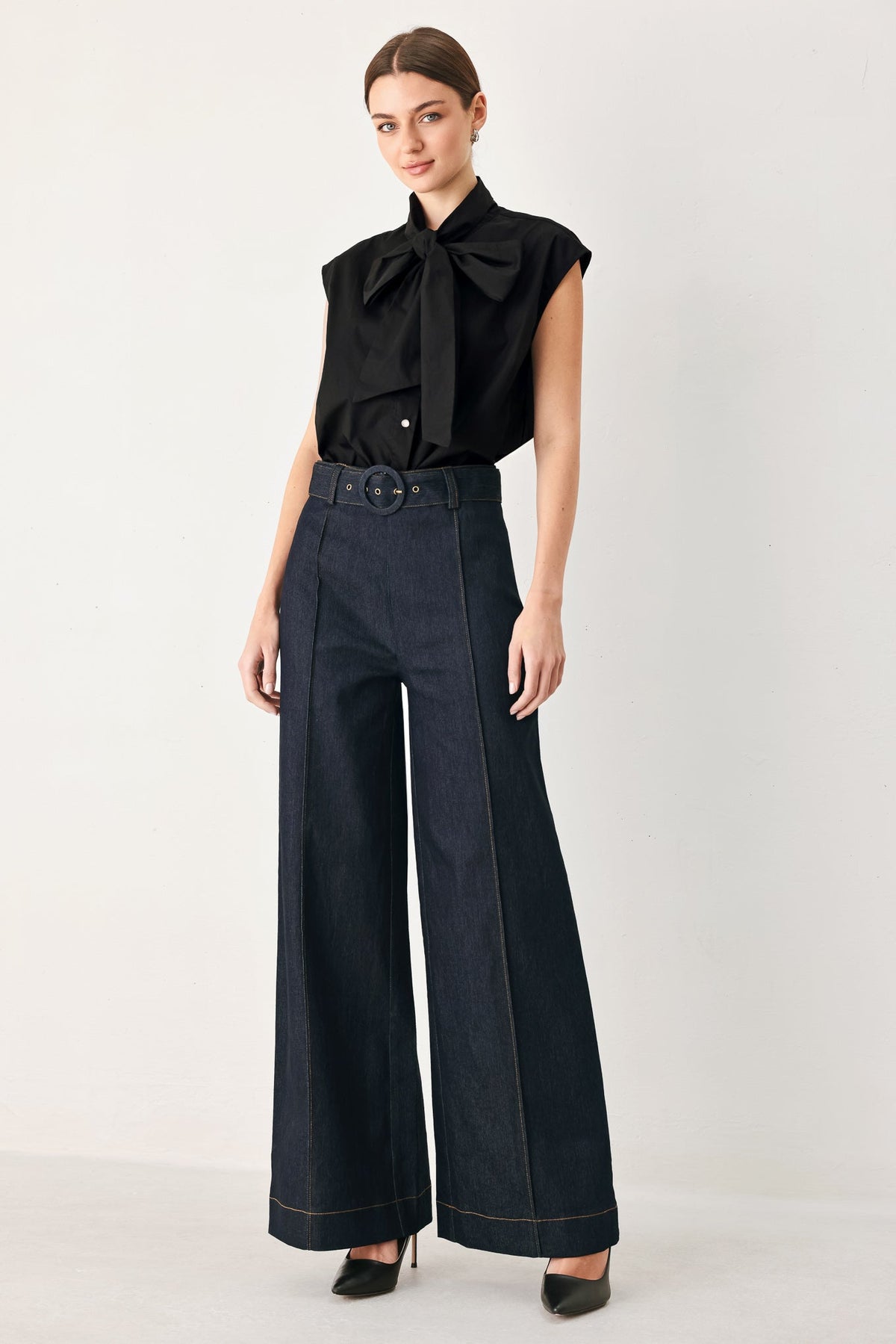 Dark wash Urban Stitch denim pants by Flying Tomato, shown on a mannequin with front pockets and belt loops.