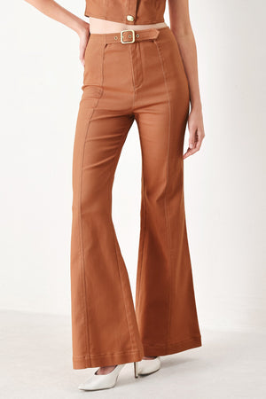Terracotta woven pants by Flying Tomato from the Sahara Edit, featuring a relaxed fit and textured fabric.