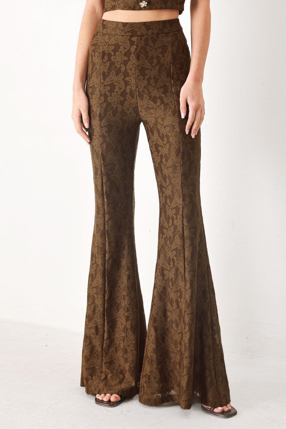 Flying Tomato Moonlight Boho woven pants in brown with relaxed fit and intricate woven patterns, displayed lying flat.