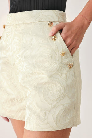 Cream gold marzipan floral woven jacquard shorts by Flying Tomato, featuring intricate floral patterns and tailored fit.