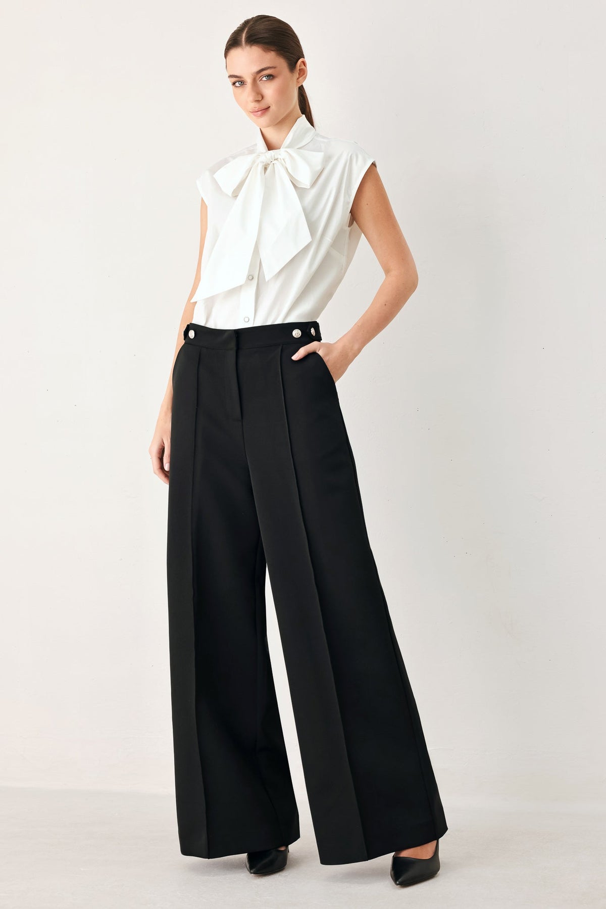Black Power Palazzo woven pants by Flying Tomato, featuring wide-leg design and textured fabric, shown on a model.