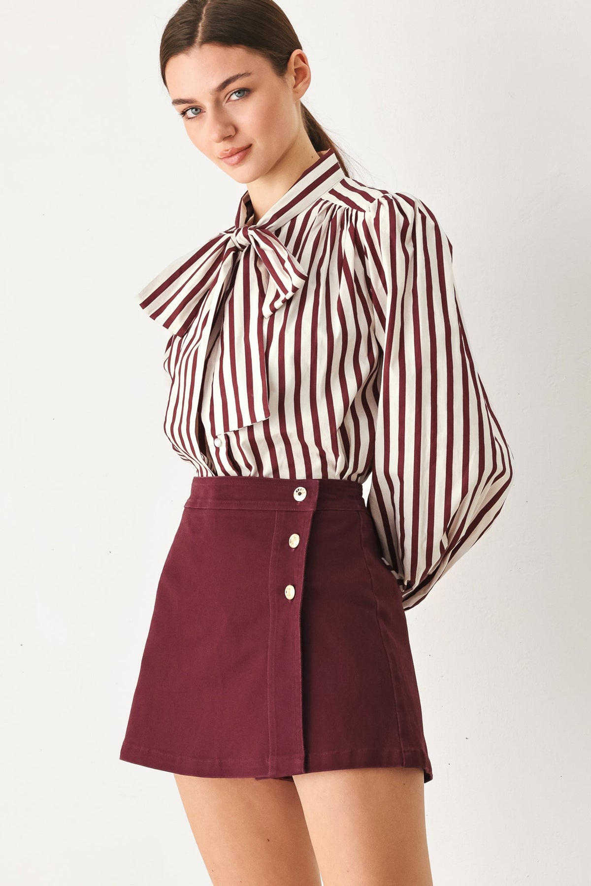 Flying Tomato Merlot Ridge woven skort in burgundy, showing the front view with a subtle woven texture and side pockets.