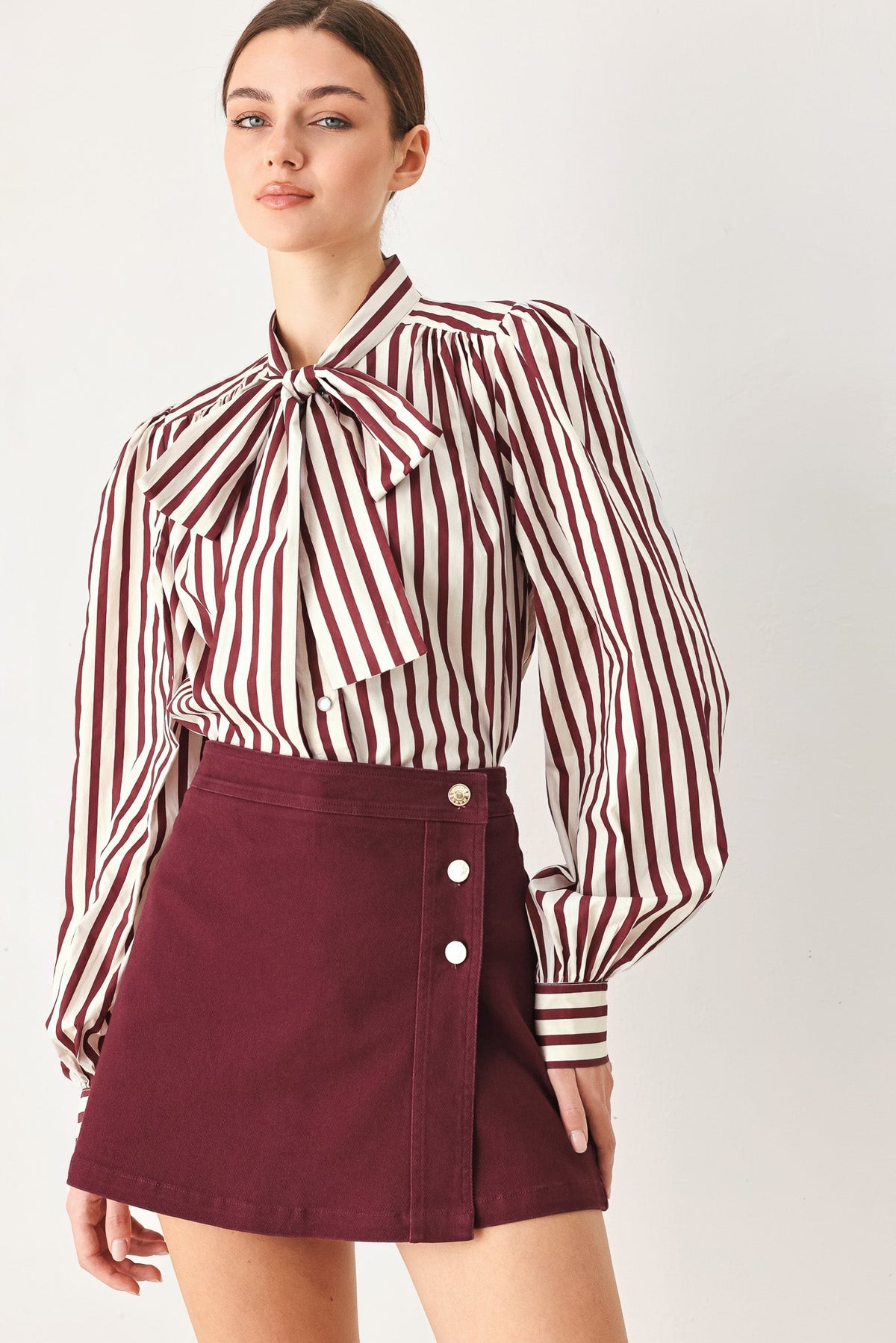 Flying Tomato Merlot Ridge woven skort in burgundy, showing the textured fabric, front zipper, and waistband detail.
