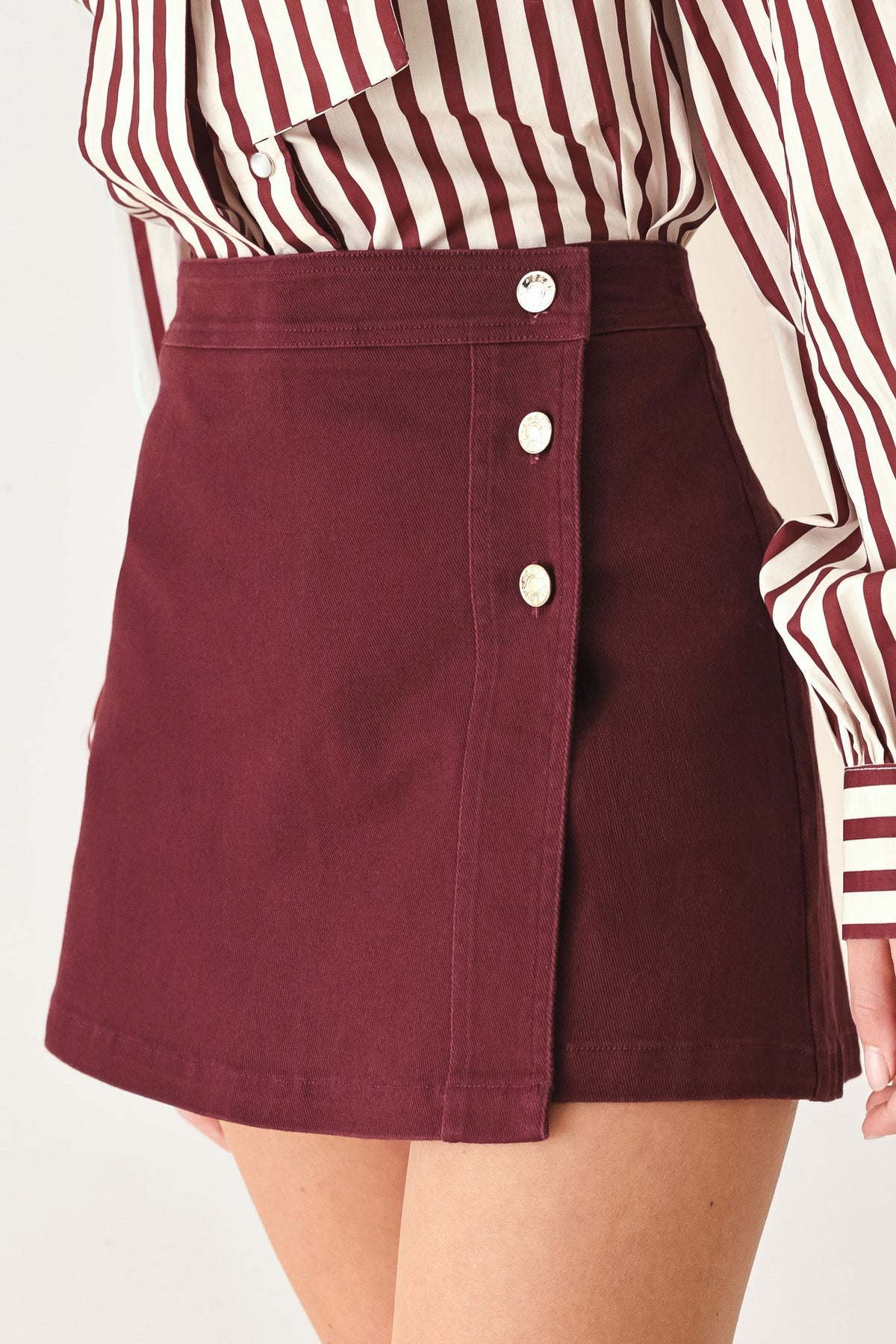 Flying Tomato Merlot Ridge woven skort in burgundy, featuring a stylish design with a comfortable fit and detailed fabric texture.