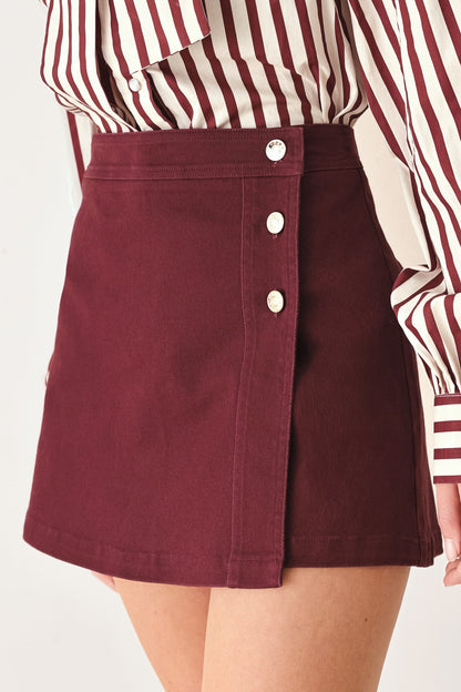 Flying Tomato Merlot Ridge woven skort in burgundy, featuring a stylish design with a comfortable fit and detailed fabric texture.