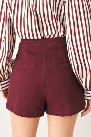 Flying Tomato Merlot Ridge woven skort in burgundy, lightweight fabric with a comfortable waistband and side pockets.