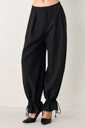 Flying Tomato Noir drawstring woven pants in black, featuring a relaxed fit and adjustable waistband.