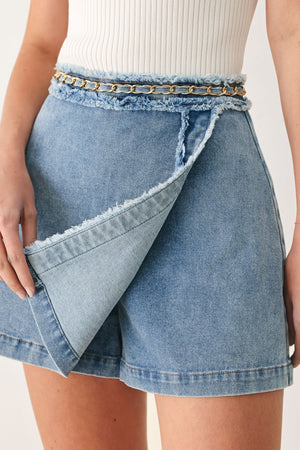 Flying Tomato Skyward Linked Denim Crop Skort in light denim, showing front view with adjustable waistband and stitched detailing.
