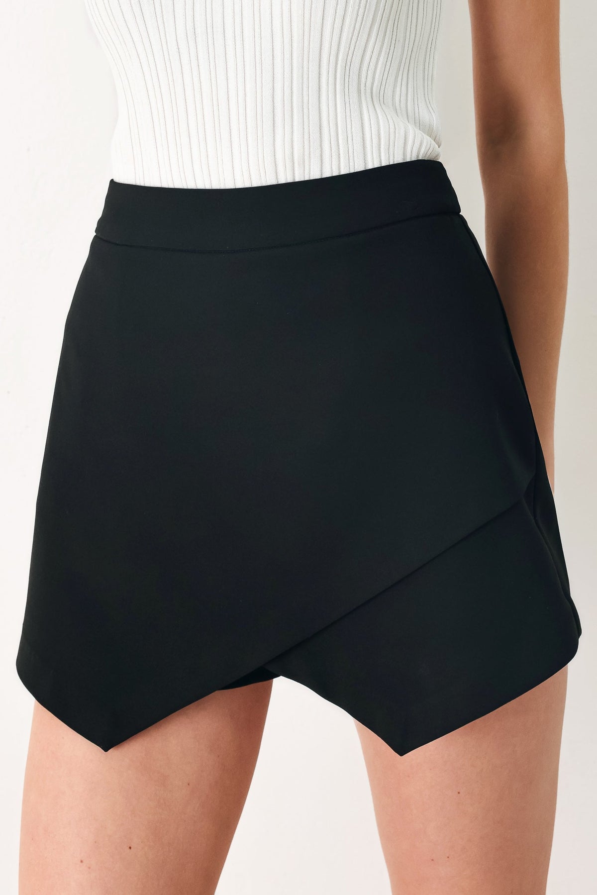 Flying Tomato Uptown Flirt woven skort in black, featuring a stylish design with a comfortable waistband and woven fabric.