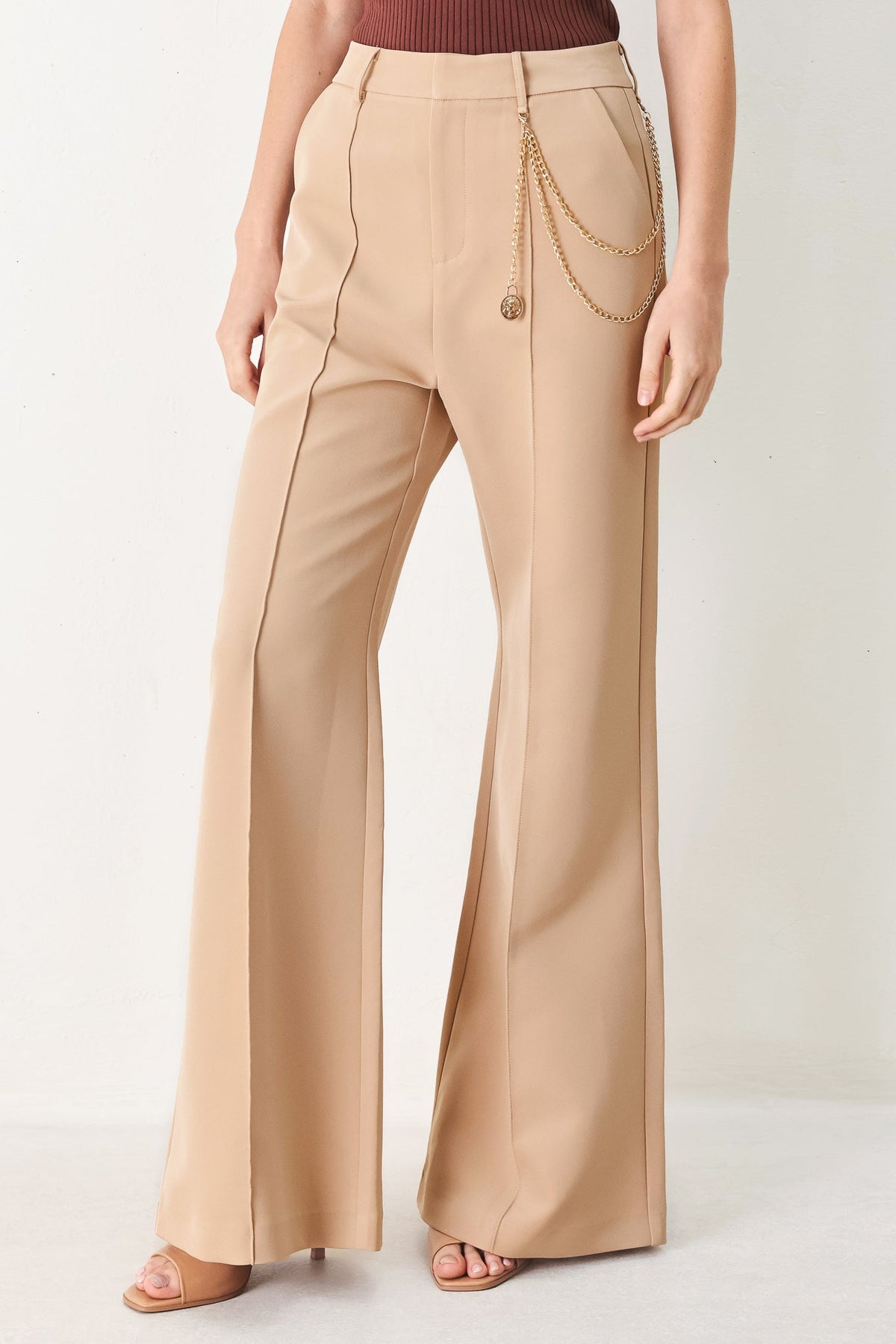 Flying Tomato Crystal Bay woven pants in camel color with a relaxed fit and textured fabric, displayed on a hanger.