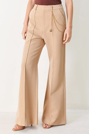Flying Tomato Crystal Bay woven pants in camel color with a relaxed fit and textured fabric, displayed on a hanger.