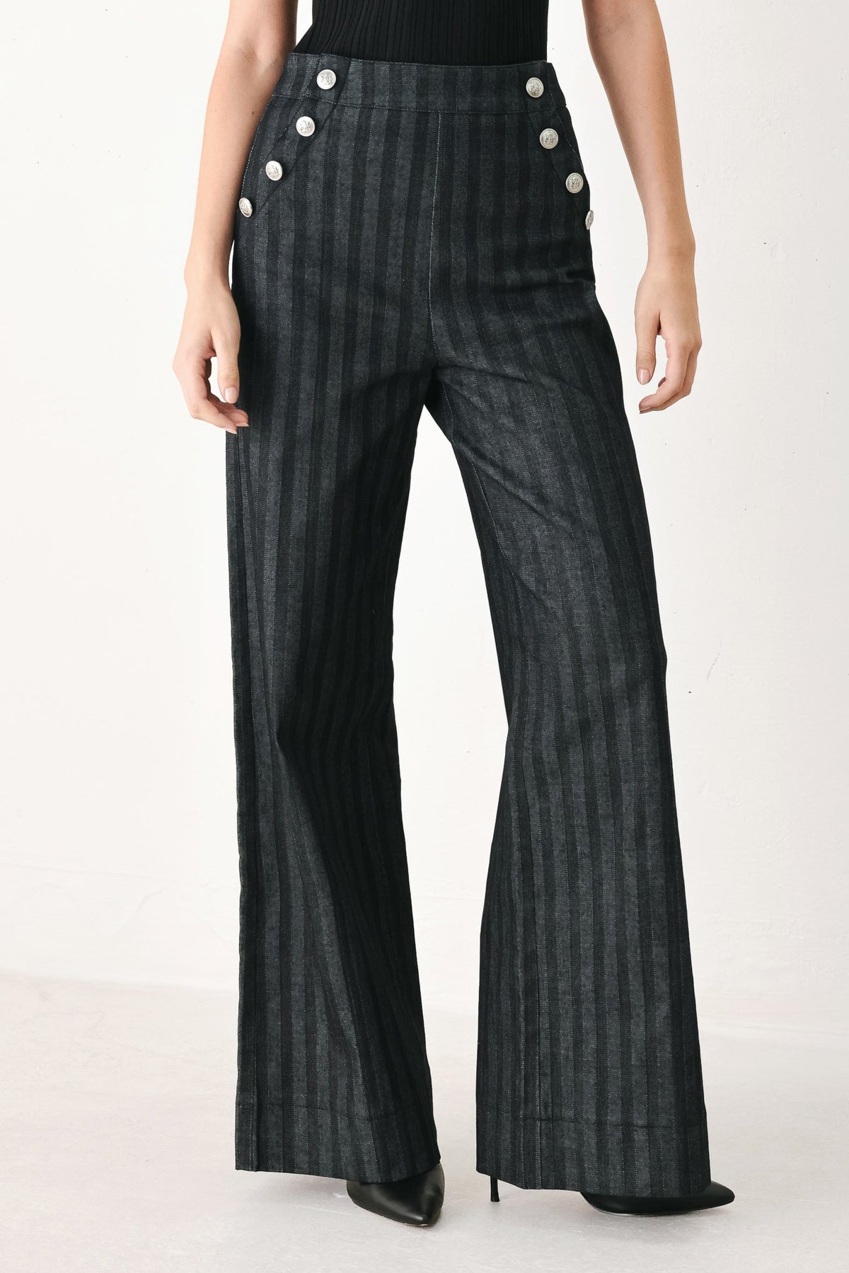 Black Graphite City Woven Pants by Flying Tomato, showing the relaxed fit and detailed woven fabric.
