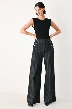 Black Graphite City Woven Pants by Flying Tomato, showcasing the relaxed fit and woven fabric details.