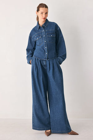 Medium indigo pleated denim wide-leg pants by Flying Tomato with a relaxed fit and stylish design.