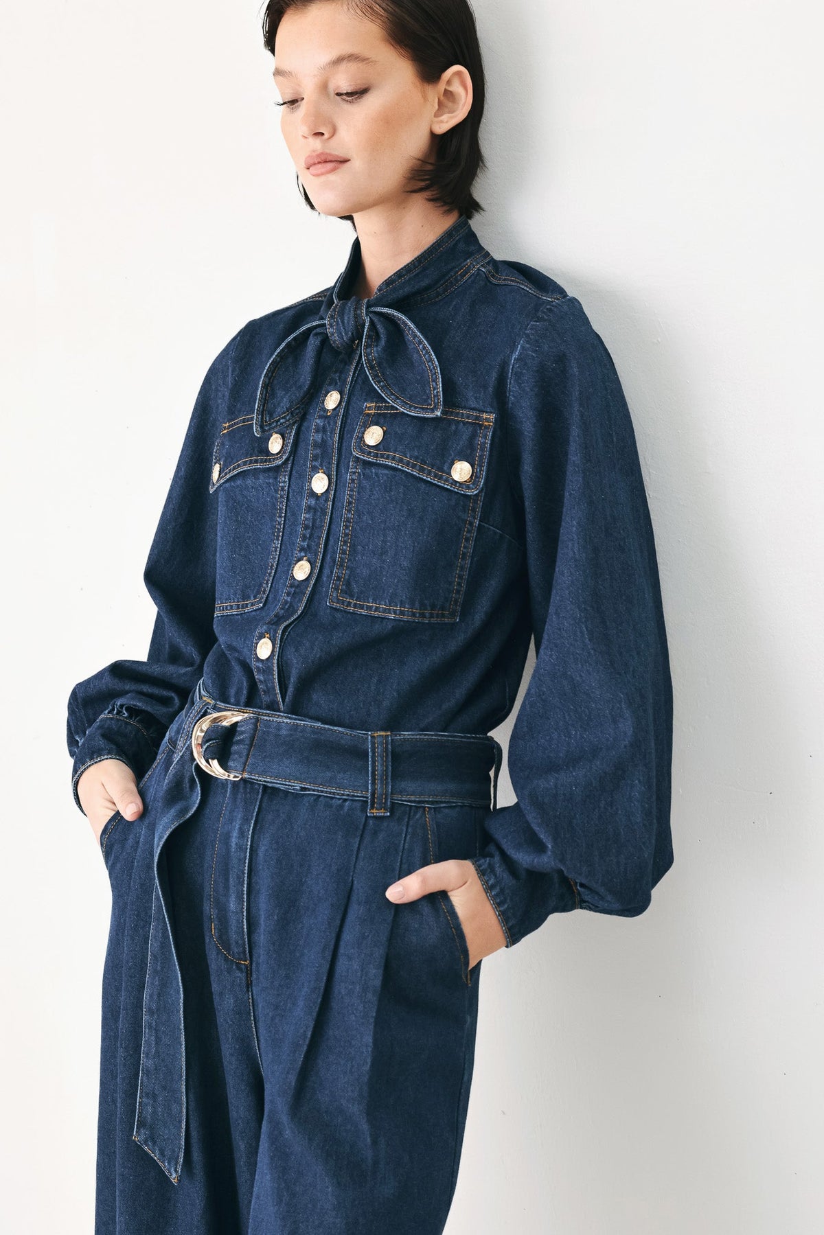 Deep indigo modern Muse denim pants by Flying Tomato, showcasing a slim fit with classic five-pocket style and belt loops.