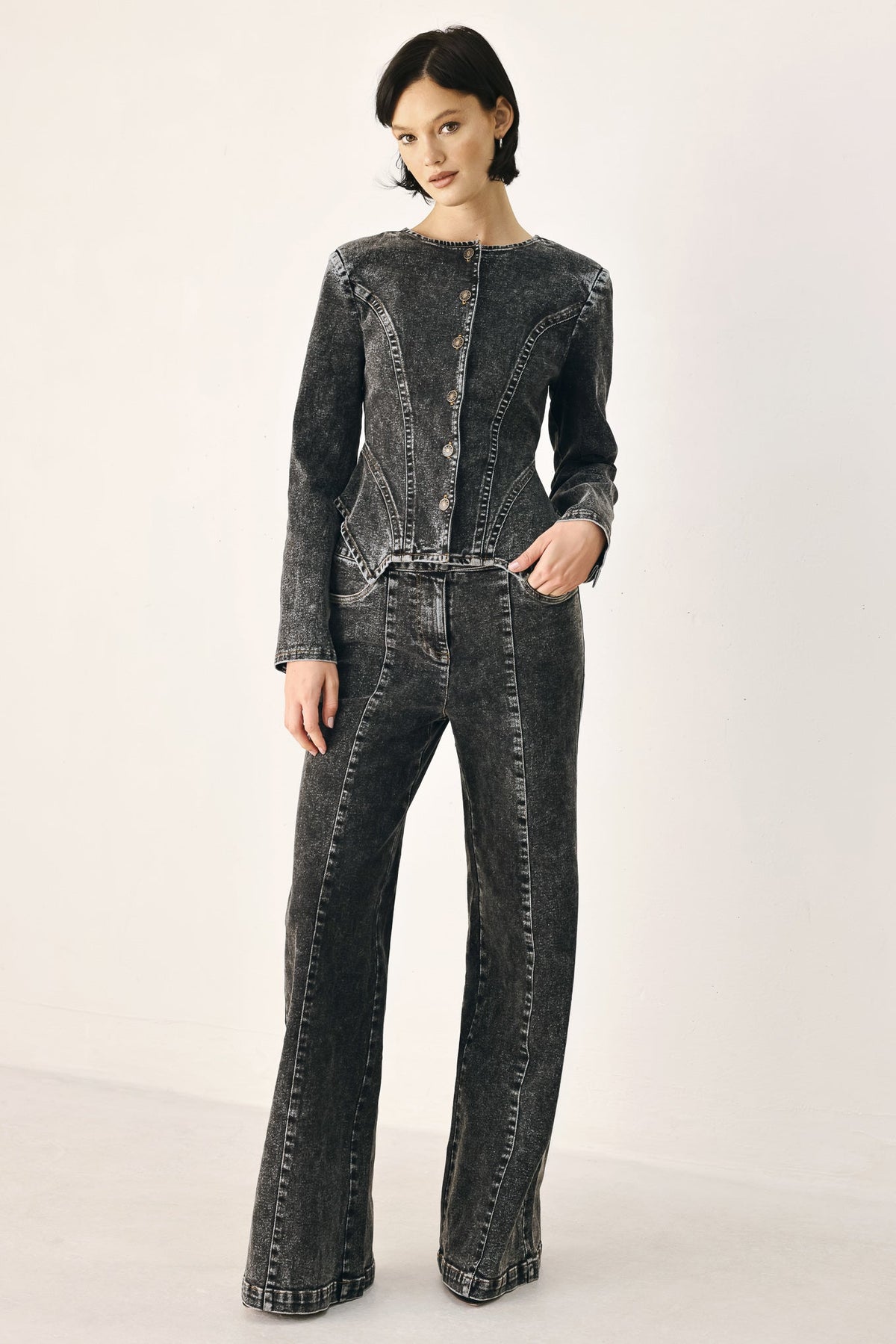 Black Flying Tomato Downtown Edge crossover denim pants with stylish design and fitted silhouette, shown on a model.