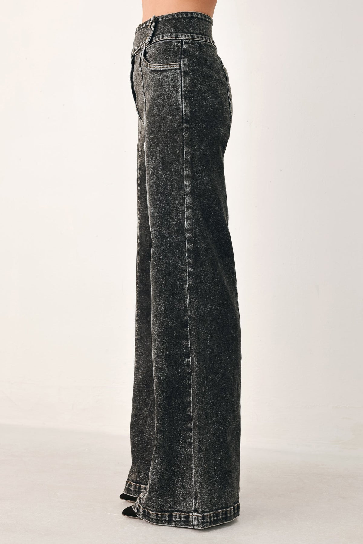 Black Flying Tomato Downtown Edge crossover denim pants with stylish design and fitted cut, shown on a model.