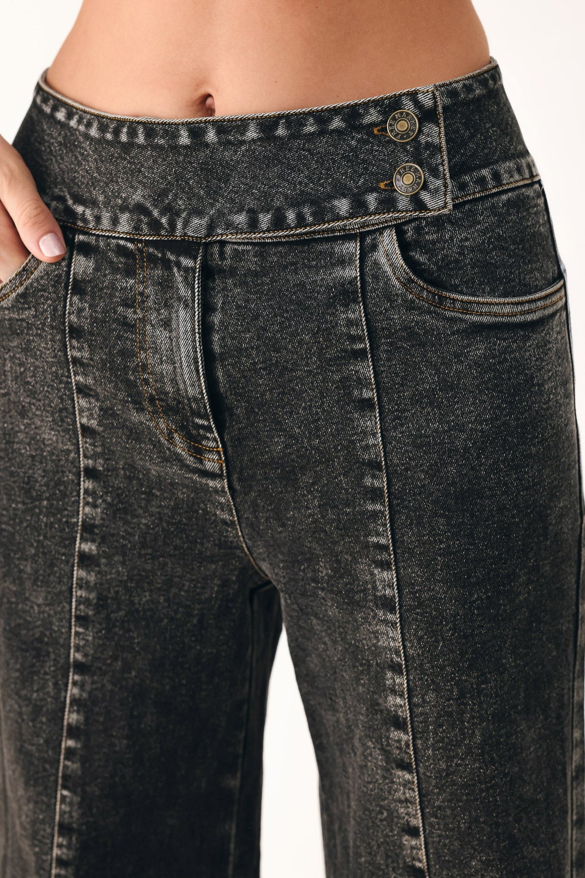 Flying Tomato Downtown Edge crossover denim pants in black, showing the stylish high-waisted design and fitted silhouette.