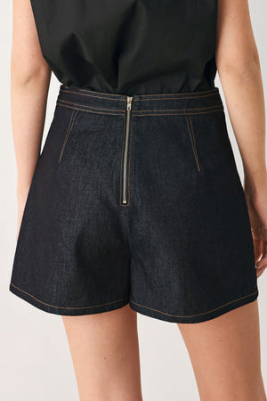Dark denim Flying Tomato modern prep denim skort with front pockets and a sleek, stylish design.