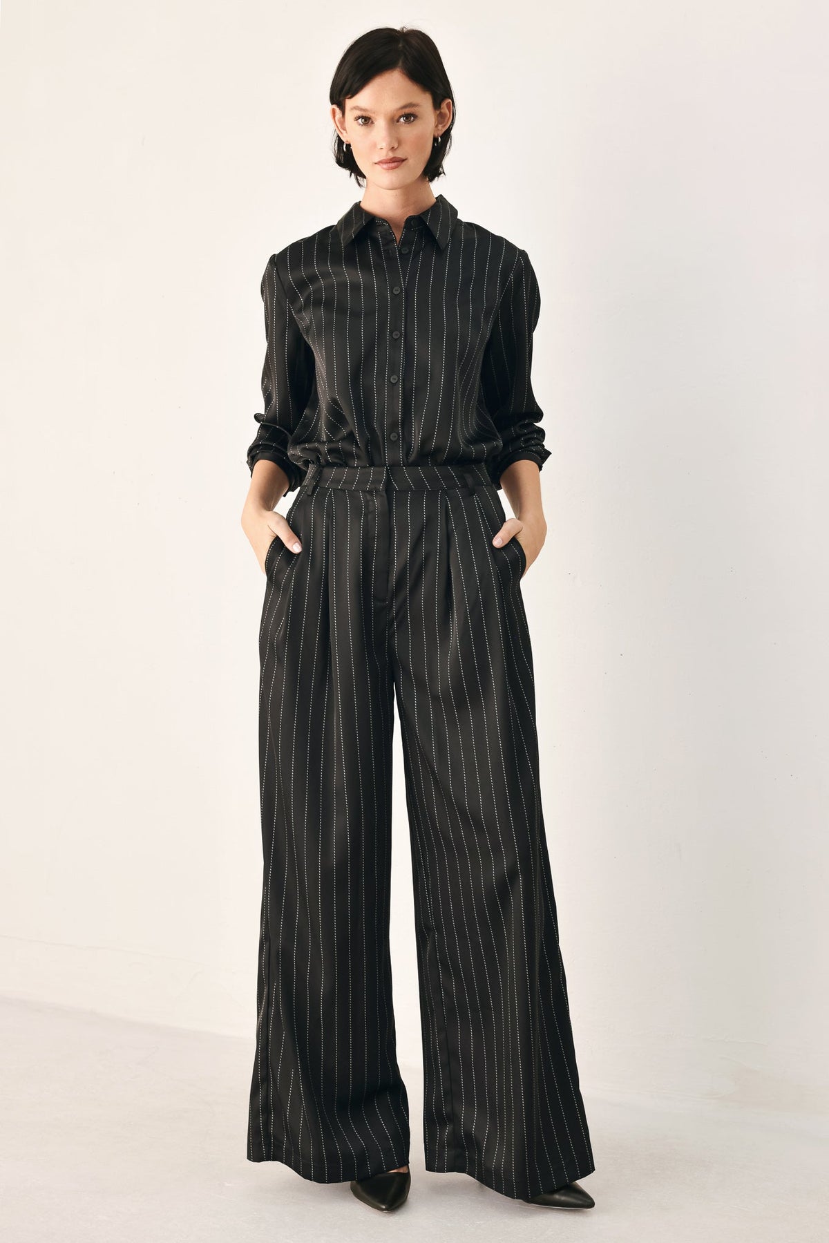 Black striped wide-leg pants from Flying Tomato's City After Dark collection, showcasing relaxed fit and stylish pattern.